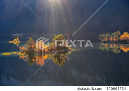 Fabulous autumn  landscape of islands with pine-trees in the middle of Eibsee lake. 130065384
