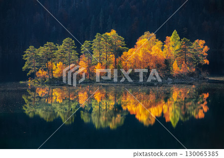 Amazing autumn landscape of islands with pine-trees in the middle of Eibsee lake. Amazing autumn landscape of islands with pine-trees in the middle of Eibsee lake. 130065385