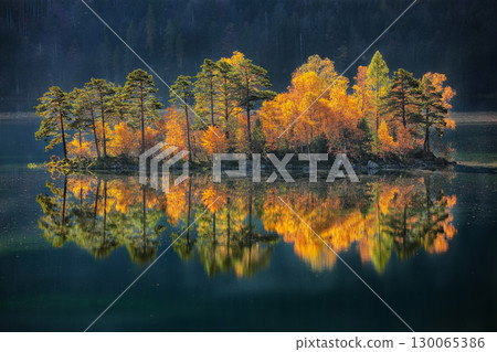 Fabulous autumn landscape of islands with pine-trees in the middle of Eibsee lake. Fabulous autumn landscape of islands with pine-trees in the middle of Eibsee lake. 130065386
