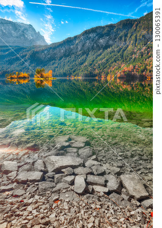 Amazing autumn landscape of Eibsee Lake in front of Zugspitze summit under sunlight. Amazing autumn landscape of Eibsee Lake in front of Zugspitze summit under sunlight. 130065391