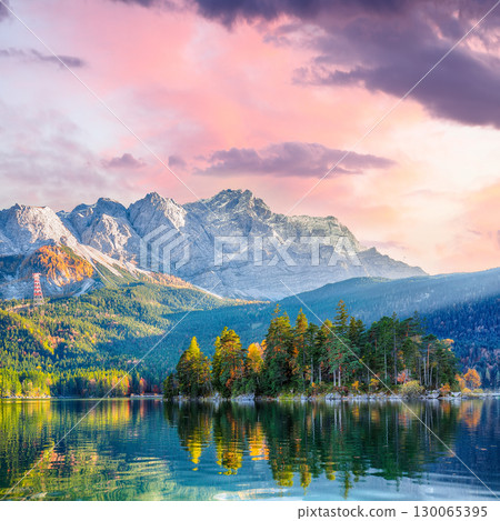 Stunning autumn landscape of Eibsee Lake in front of Zugspitze summit under sunset Stunning autumn landscape of Eibsee Lake in front of Zugspitze summit under sunset 130065395