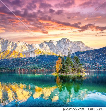 Stunning autumn landscape of Eibsee Lake in front of Zugspitze summit under sunset Stunning autumn landscape of Eibsee Lake in front of Zugspitze summit under sunset 130065396
