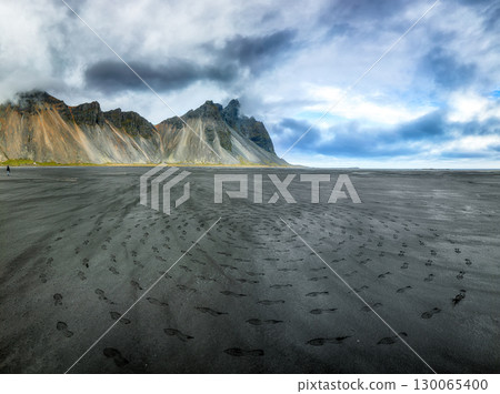 Amazing nasty day and dramatic black sand beach on Stokksnes cape in Iceland Amazing nasty day and dramatic black sand beach on Stokksnes cape in Iceland 130065400