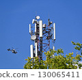 Mobil antenna tower and a helicopter in the background 130065411