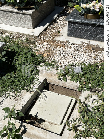 New empty place for a tombstone in the public cemetery 130065423