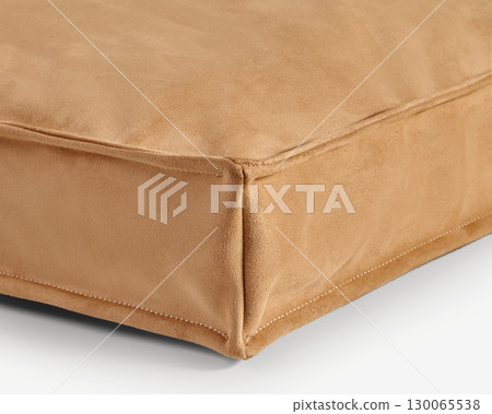 Close-up of light brown suede cushion corner showing stitching detail 130065538