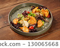Delicious caesar salad with chicken, croutons, parmesan, and cherry tomatoes on rustic wooden table 130065668