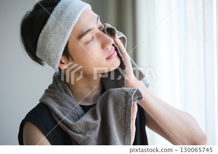 Young Asian man portrait after washing his face Young Asian man portrait after washing his face 130065745