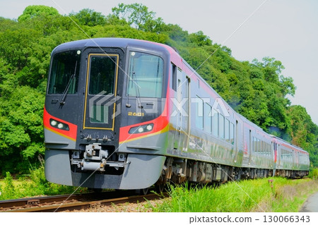 2600 series train running with additional cars on a summer day 130066343