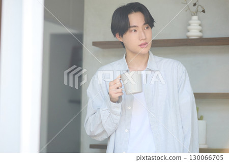 Young Asian man relaxing at home Young Asian man relaxing at home 130066705