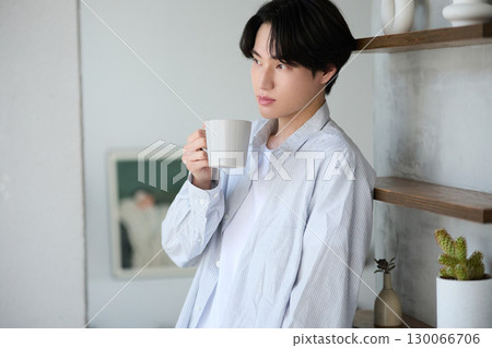 Young Asian man relaxing at home Young Asian man relaxing at home 130066706