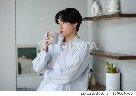 Young Asian man relaxing at home Young Asian man relaxing at home 130066709