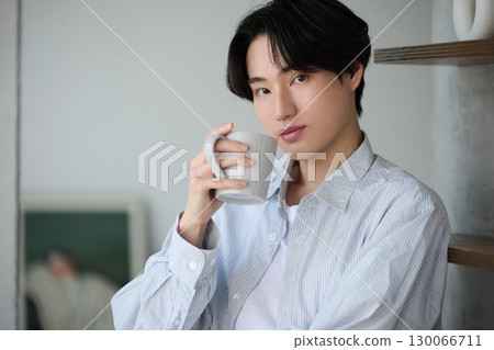 Young Asian man relaxing at home Young Asian man relaxing at home 130066711