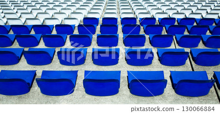 Empty Blue Stadium Seats Arranged in Perfect Geometric Rows at Sports Venue 130066884
