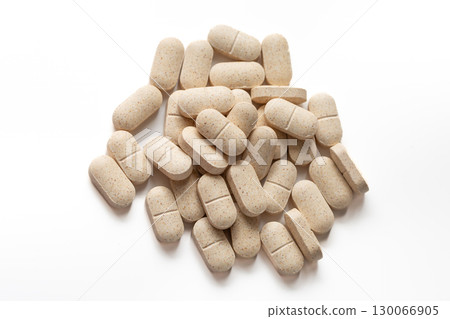 Natural Beige Vitamin Capsules Scattered on Clean White Background for Health Branding Natural Beige Vitamin Capsules Scattered on Clean White Background for Health Branding 130066905
