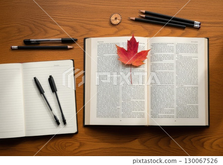 Back to School Still Life: Open Textbook and Stationery on Desk 130067526