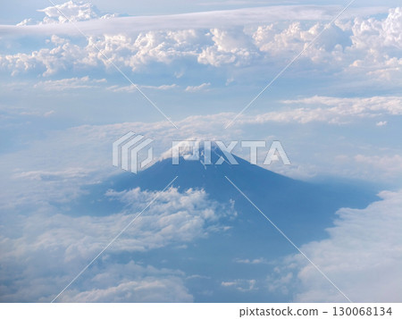 Spectacular view of Mt. Fuji and the sea of clouds from an airplane window 130068134