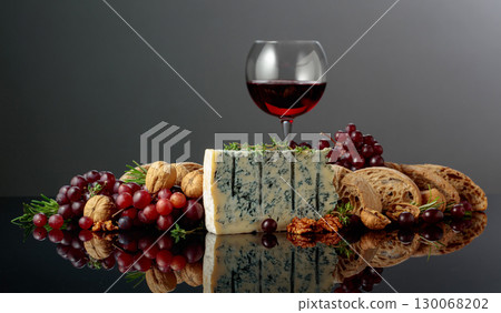 Gorgonzola cheese with ciabatta, walnuts, grapes, and red wine. 130068202