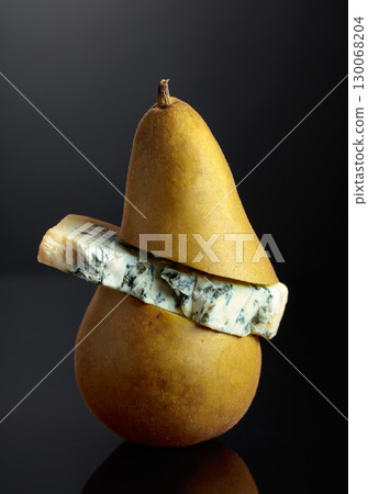 Blue cheese with pear on a black background. 130068204