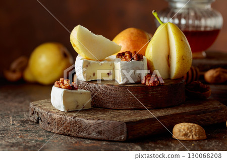 Camembert cheese with pears, walnuts, and honey. 130068208