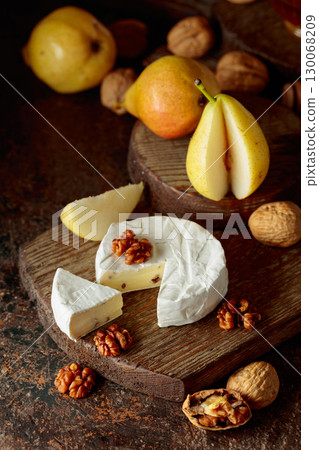 Camembert cheese with pears, walnuts, and honey. 130068209