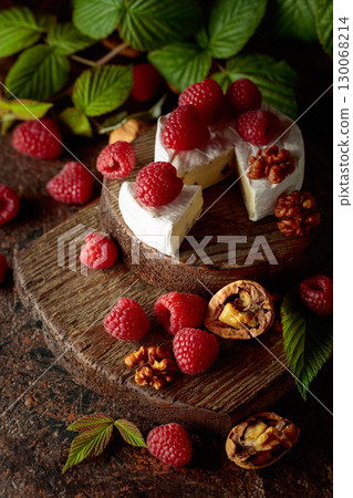 Camembert cheese with fresh raspberries and walnuts. Camembert cheese with fresh raspberries and walnuts. 130068214