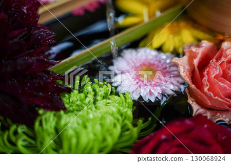 Flowers displayed at the Chozuya (purification fountain) of a temple in Kyoto 130068924