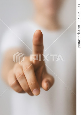 Hand pointing forward with index finger, close up gesture, human interaction symbol 130069054