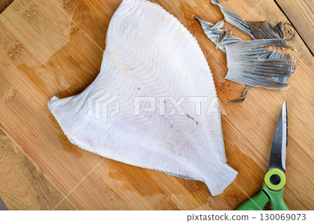 Flounder fish with fins and tail cut off before cooking. 130069073