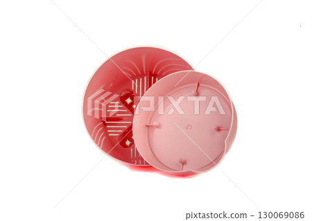Pink plastic empty flower pot with tray on white background. 130069086