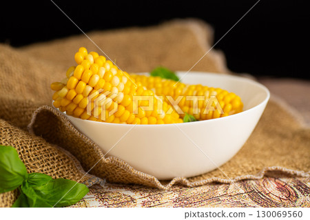 boiled corn with basil leaves in a bowl 130069560