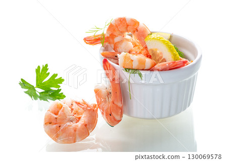 Boiled red shrimps with lemon on white background Boiled red shrimps with lemon on white background 130069578