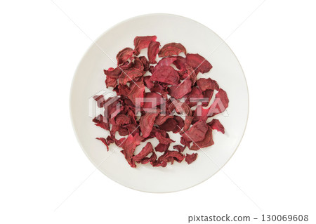 Top view. Ingredient for preparing a freeze-dried lunch. Dried beetroot on a ceramic plate isolated on a white background. Top view. Ingredient for preparing a freeze-dried lunch. Dried beetroot on a ceramic plate isolated on a white background. 130069608