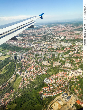 Airplane view over Belgrade city with wing in frame. Urban infrastructure, residential areas and city planning from above. Airplane view over Belgrade city with wing in frame. Urban infrastructure, residential areas and city planning from above. 130069642
