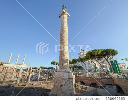 ROME, ITALY - AUGUST 01, 2025 Trajan's Column that commemorates Roman emperor victory in the Dacian Wars, located in Trajan's Forum with ancient ruins and classical architecture surrounding it 130069663