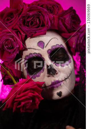 Portrait of Girl With Calavera Makeup and Roses for Dia De Muertos 130069669