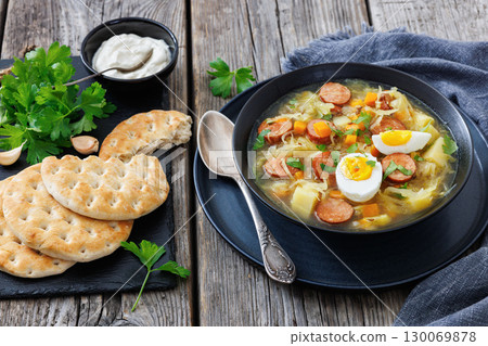 Polish sauerkraut soup with sausage in a bowl Polish sauerkraut soup with sausage in a bowl 130069878