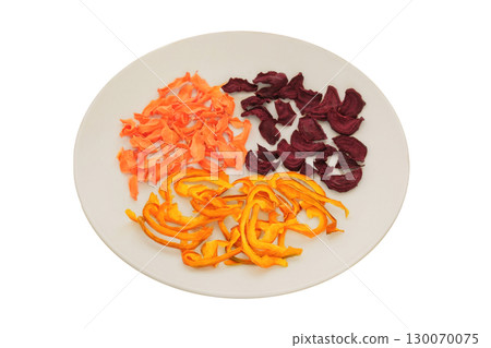 Ingredient for preparing a freeze-dried lunch. Dried beetroot, sweet pepper and carrot on a ceramic plate isolated on a white background. Various dry of vegetables. Ingredient for preparing a freeze-dried lunch. Dried beetroot, sweet pepper and carrot on a ceramic plate isolated on a white background. Various dry of vegetables. 130070075