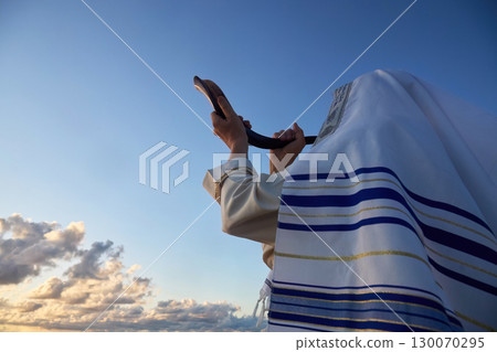 Jewish man blowing the Shofar horn of Rosh Hashanah - New Year. Horizon Ritual 130070295