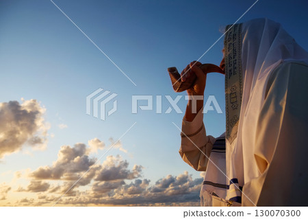 Jewish man blowing the Shofar horn of Rosh Hashanah. New Year. 130070300