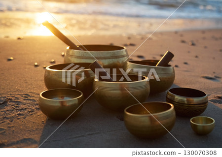 Singing Bowls on Beach at sunrise. Singing Bowls on Beach at sunrise. 130070308
