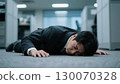 Businessman tired from work and collapsed in the office (exhaustion, despair, feeling of defeat, sudden illness) 130070328