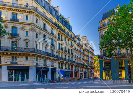 Paris city street in Le Marais historic district, traditional Parisian architecture apartment building with typical facade, balconies and windows iron fences, typical French house on crossroad Paris city street in Le Marais historic district, traditional Parisian architecture apartment building with typical facade, balconies and windows iron fences, typical French house on crossroad 130070449