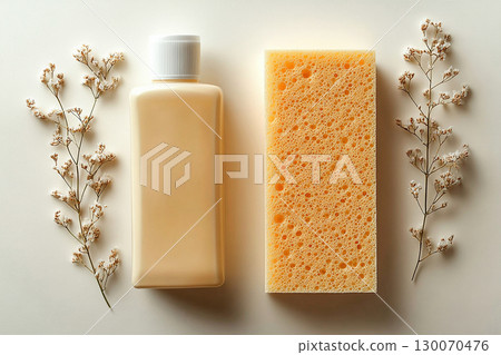 Bathroom cleaning. Autumn style. Commercial use. Top view of sponge next to a light detergent bottle with blank labels on a background in beige colors. 130070476