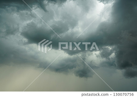 Dark storm clouds with heavy rain streaks forming in dramatic sky before a summer thunderstorm 130070756