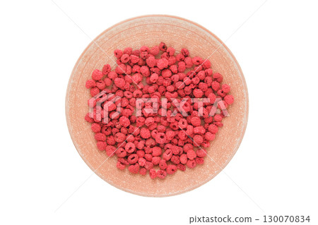 Homemade preparation of snack. Top view. Dried raspberries on a ceramic plate isolated on a white background. 130070834