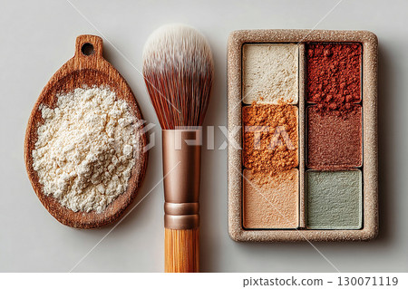 Ideal for beauty brands or cosmetic advertisements. Flat lay of makeup brush placed next to a color palette on white background. 130071119
