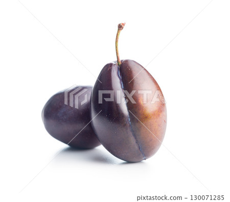 Ripe plums isolated on white background. 130071285