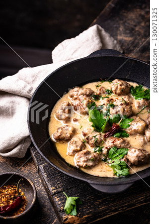 Meatballs in sour cream sauce in a frying pan Meatballs in sour cream sauce in a frying pan 130071325