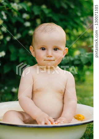 Baby Sitting In Basin With Water Drops On Skin Baby Sitting In Basin With Water Drops On Skin 130071385